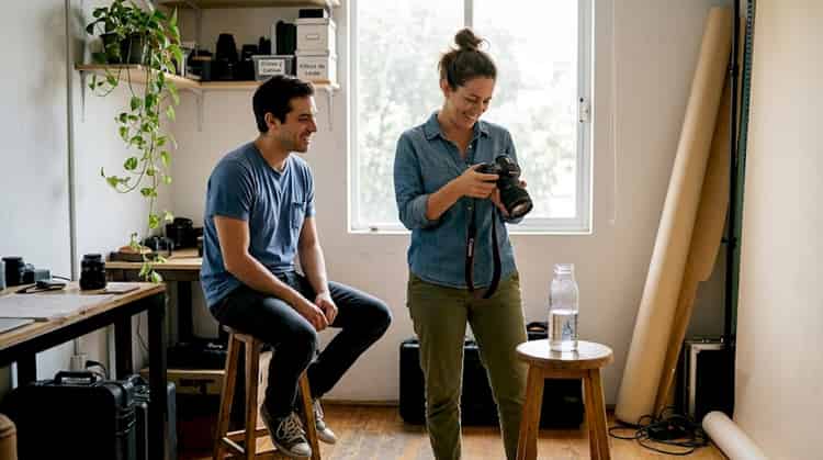 The photographer and the model collaborate during a session in the studio, exchanging ideas and posing to capture the best images.